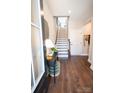 Inviting entryway with hardwood floors, stairs to the upper level, and a stylish console table with decor at 317 Old Town Village Rd, Waxhaw, NC 28173
