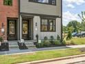Eye-level capture of a home's entrance, showcasing manicured shrubs, painted door and a well-kept lawn at 317 Old Town Village Rd, Waxhaw, NC 28173