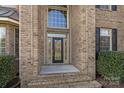 Elegant front entrance with a large window above the door and brick accents at 3907 Voltaire Dr, Monroe, NC 28110