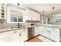 Bright kitchen with stainless steel appliances, granite countertops, window, and custom cabinets at 401 Dakota St, Kannapolis, NC 28083
