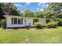 Close up of a cozy one story home with shuttered windows and simple landscaping on a verdant lawn at 5275 Long Ferry Rd, Salisbury, NC 28146