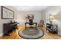 Dedicated home office featuring hardwood floors, a large desk, and ample natural light, perfect for remote work at 5309 Silchester Ln, Charlotte, NC 28215