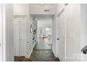 Welcoming entryway with slate floors leading to bright living area, adjacent to a double-door closet at 5909 Quail Hollow Rd # B, Charlotte, NC 28210