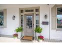 Inviting front entrance features a glass-paneled door, stylish lighting, and potted plants at 615 E Sycamore St, Lincolnton, NC 28092