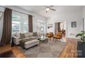 Bright living room with hardwood floors, large windows, and comfortable seating at 615 E Sycamore St, Lincolnton, NC 28092