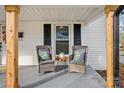 Close up of a charming front porch, showcasing a cozy seating area with decorative pillows at 691 Gibson Nw Dr, Concord, NC 28025