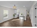 Bright living space with hardwood floors, modern lighting, and open layout leading to the kitchen at 691 Gibson Nw Dr, Concord, NC 28025