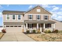 Inviting home showcasing a spacious front yard, attached garage and covered front porch at 7436 Meridale Forest Dr, Charlotte, NC 28269