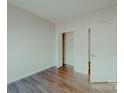Cozy bedroom featuring sleek floors, neutral paint, and an ensuite bathroom entrance at 945 3Rd Street Sw Pl, Hickory, NC 28602
