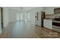 Bright living room with stainless steel appliances, granite counters, and wood-look flooring at 945 3Rd Street Sw Pl, Hickory, NC 28602