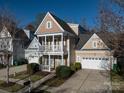 Two-story home featuring a charming front porch and a convenient two-car garage at 10133 Caldwell Forest Rd, Charlotte, NC 28213