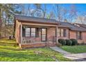 Attractive brick home with a shaded porch and lush green lawn at 118 Ashleigh Ct, Fort Mill, SC 29715