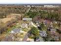 Aerial view of the property showcasing its location in a wooded neighborhood near commercial area at 123 Southhaven Dr, Mooresville, NC 28117