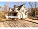A charming home shows its inviting side entrance, a spacious driveway, and a cozy front porch at 1256 Twin Lakes Rd, Rock Hill, SC 29732