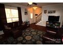 Inviting living room with dark wood floors, a plush sofa, and ample natural light from a large window at 1256 Twin Lakes Rd, Rock Hill, SC 29732