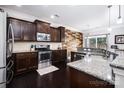 Well-equipped kitchen featuring granite countertops, stainless steel appliances and a stylish backsplash at 128 Millen Dr, Mooresville, NC 28115
