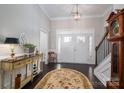 Elegant foyer with dark wood flooring, a decorative rug, and a staircase at 138 Margo Ln, Statesville, NC 28677