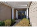 Inviting entrance featuring double doors, stone accents, and a cozy bench, perfect for relaxing at 138 Margo Ln, Statesville, NC 28677