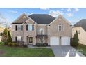 Beautiful two-story brick home with a well-kept lawn and a two-car garage at 15138 Callow Forest Dr, Charlotte, NC 28273