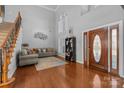 Grand foyer featuring hardwood floors, a staircase, and a stunning front door at 15138 Callow Forest Dr, Charlotte, NC 28273