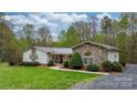 Beautiful ranch home with stone and siding details, a metal roof, and well-kept landscaping at 1514 Ring Tail Rd, Claremont, NC 28610