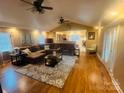 Cozy living room featuring hardwood floors, a ceiling fan, and plenty of natural light at 1514 Ring Tail Rd, Claremont, NC 28610