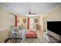 Relaxing living room features a light blue sofa, ottoman, hardwood floors, and neutral walls, perfect for unwinding at 15920 Fieldstone Dr, Matthews, NC 28104