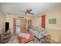 Cozy living room with soft blue sofa, colorful rug, and decorative accents create a warm, inviting space at 15920 Fieldstone Dr, Matthews, NC 28104