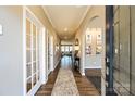 Inviting home entryway featuring a wood floor, interior doors with glass, and an open concept design at 1766 Loggerhead Dr, Lancaster, SC 29720