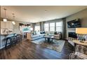 Open-concept living room and kitchen, hardwood flooring, fireplace, and large windows at 1766 Loggerhead Dr, Lancaster, SC 29720