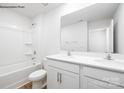 Bathroom with double sink vanity with white countertop, white cabinets and tub with shower at 2319 Riggs Rd, Sherrills Ford, NC 28673