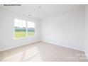 Bright bedroom with a large window and neutral carpet at 2319 Riggs Rd, Sherrills Ford, NC 28673