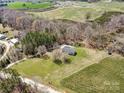 Aerial view showcasing the home's placement on a large lot with neighboring properties and verdant land at 260 Charlie Stacks Rd, Lancaster, SC 29720