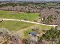 Expansive aerial view of the property, including the lawn, nearby pond, and surrounding wooded area at 260 Charlie Stacks Rd, Lancaster, SC 29720