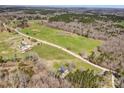 Overhead shot features the home, adjacent fields, pond, and surrounding lush greenery at 260 Charlie Stacks Rd, Lancaster, SC 29720