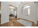 Inviting foyer with hardwood floors, arched doorway, and a view into a bright office space at 2622 Sheffield Crescent Ct, Charlotte, NC 28226