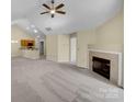 Spacious living area featuring a fireplace, ceiling fan, and an open concept design at 2905 Polo View Ln, Matthews, NC 28105