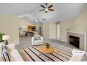 Bright living room with a fireplace, neutral colors, and an open floor plan at 2905 Polo View Ln, Matthews, NC 28105