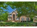 Charming brick home with a well-kept lawn and mature trees providing shade at 3017 Chisholm Ct, Waxhaw, NC 28173