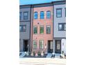 Three-story brick townhouse with black framed windows and doors, surrounded by modern landscaping at 403 Old Town Village Rd, Waxhaw, NC 28173