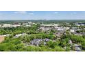 An aerial view showcases the neighborhood's lush greenery and proximity to the city skyline at 5001 Sharon Rd # H, Charlotte, NC 28210