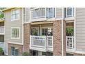 The condo has lovely brick accents and a covered patio with chairs at 5001 Sharon Rd # H, Charlotte, NC 28210