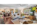 Bright living room featuring hardwood floors, large windows, and stylish furnishings at 5001 Sharon Rd # H, Charlotte, NC 28210