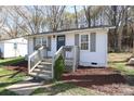 Inviting home boasting a lovely front porch, freshly landscaped yard, and a charming facade at 517 Roberts Ave, York, SC 29745