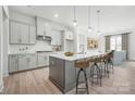 Modern kitchen featuring a large island, stainless steel appliances, and pendant lighting at 5301 Mint Harbor Way # 0315, Charlotte, NC 28269
