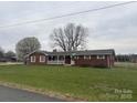 Charming brick home with a covered front porch and expansive lawn at 5643 Twinkle Dr, Concord, NC 28025