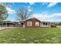 Single-story home with brick exterior, an American flag, and well-kept lawn at 5643 Twinkle Dr, Concord, NC 28025