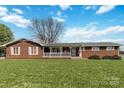 Inviting single-story brick home with a covered front porch and well-maintained lawn at 5643 Twinkle Dr, Concord, NC 28025