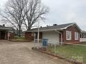 Brick home featuring a covered garage and well-maintained yard at 5643 Twinkle Dr, Concord, NC 28025