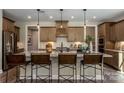 Kitchen island boasts granite countertops and stylish seating with pendant lighting at 6026 Gray Shadow Ct, York, SC 29745